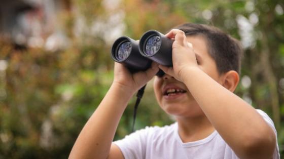 Boy looking through binoculars